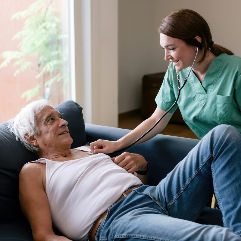 nurse taking care of senior man - old patient at home